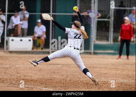 A Softball Player Is In A Windup Pitching The Ball Stock Photo