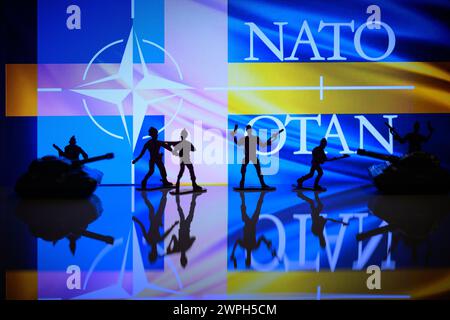 Brussels, Belgium. 07th Mar, 2024. NATO - Sweden flag visible in the background with miniature figures of solders in this photo illustration. Taken in Brussels, Belgium. On March 7, 2024. (Photo by Jonathan Raa/Sipa USA) Credit: Sipa USA/Alamy Live News Stock Photo