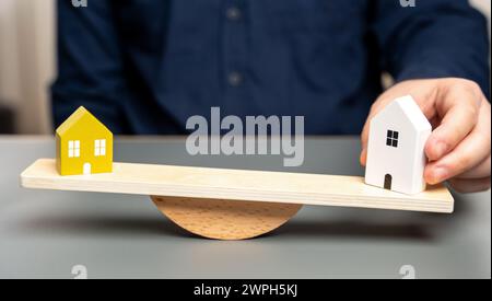 Comparison of houses. Total cost of ownership, including potential renovations and ongoing maintenance. Comparing key features like size, location, co Stock Photo