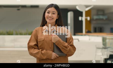 Asian chinese ethnic korean businesswoman employer in office company posing with digital tablet. Portrait happy Japanese woman corporate staff hr Stock Photo