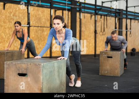 Focused woman doing cross fit in gym. Active training Stock Photo