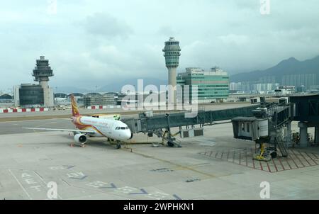 An Hong Kong Airlines airplane at the gate of the terminal at Hong Kong International Airport. Stock Photo
