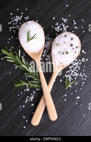 Salt with fresh rosemary and peppercorns on dark grey textured table, flat lay Stock Photo