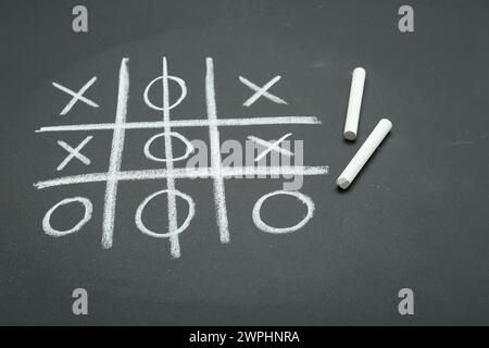 Tic tac toe game drawn on chalkboard Stock Photo