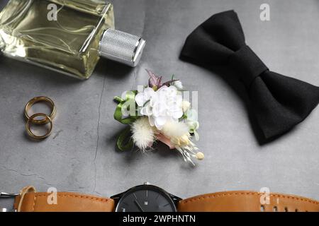 Wedding stuff. Composition with stylish boutonniere on gray background Stock Photo