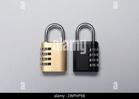 Steel combination padlocks on grey background, top view Stock Photo