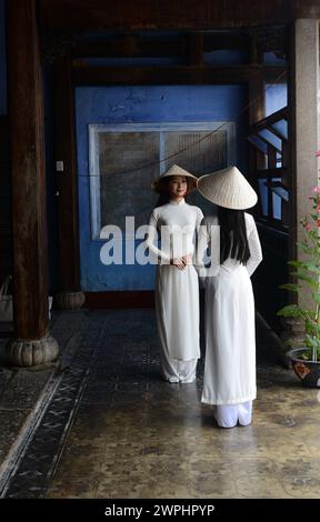 Vietnamese models in a shoot at the Hoa Van Le Nghia Buddhist temple in the old town of Hoi An, Vietnam. Stock Photo