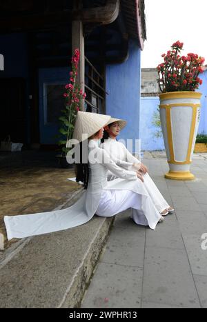 Vietnamese models in a shoot at the Hoa Van Le Nghia Buddhist temple in the old town of Hoi An, Vietnam. Stock Photo