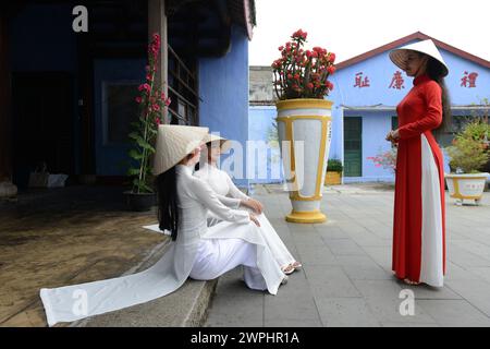 Vietnamese models in a shoot at the Hoa Van Le Nghia Buddhist temple in the old town of Hoi An, Vietnam. Stock Photo