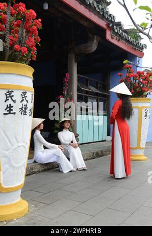 Vietnamese models in a shoot at the Hoa Van Le Nghia Buddhist temple in the old town of Hoi An, Vietnam. Stock Photo