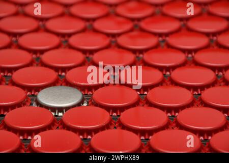 Silver and red beer caps staggered. Be different from others. Dare to be different concept Stock Photo