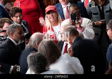 Washington, United States. 07th Mar, 2024. Rep. Marjorie Taylor Greene, R-GA, wears a 'Make America Great Again' hat and holds a pin for Laken Riley, a University of Georgia nursing student killed by an illegal immigrant while on a run, as President Joe Biden arrives at the annual State of the Union speech to a joint session of Congress at the U.S. Capitol in Washington DC on Thursday, March 7, 2024. Photo by Bonnie Cash/UPI Credit: UPI/Alamy Live News Stock Photo