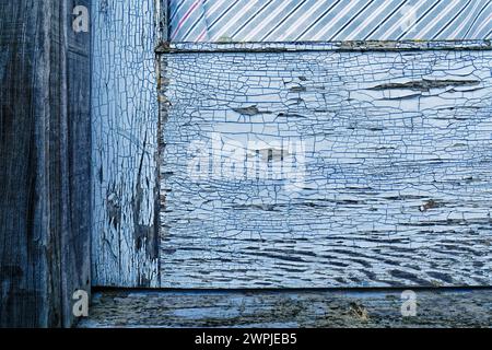 Weathered old paint cracked and peeling off of a wooden door Stock Photo