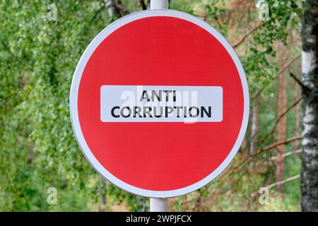ANTI CORRUPTION text writing on the sign entry is prohibited against the background of the forest Stock Photo
