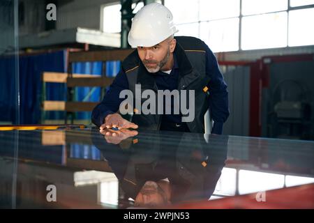 Foreman with a laptop inspects the material for double-glazed windows Stock Photo