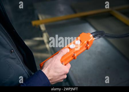 Worker in the workshop holds in his hands control panel Stock Photo