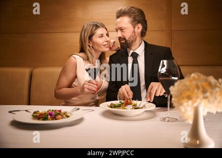 Middle-aged couple communicates over a romantic dinner in a restaurant Stock Photo