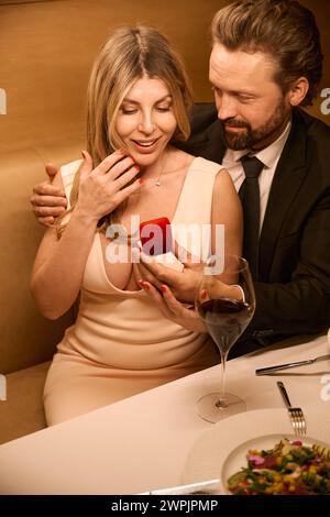 Lady holds a small red box in her hands Stock Photo