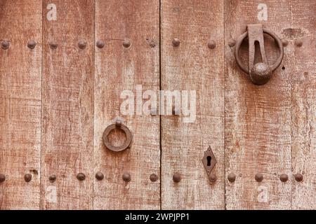 Antique wooden door with metallic doorknob. Horizontal Stock Photo