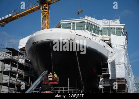 Port Glasgow, Argyll and Bute, Scotland, UK. 7th March, 2024. Latest images of new ferries under construction at Ferguson Marine shipyard in Port Glasgow on the River Clyde. Both ferries are years behind schedule and vastly over budget. Photo; Workers carrying out work on bow doors of Glen Rosa which is due to be launched in April 2024.  Iain Masterton/Alamy Live News Stock Photo
