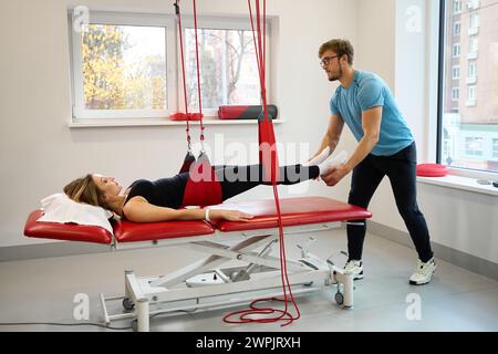 Physiotherapist uses an effective redcord in his work Stock Photo