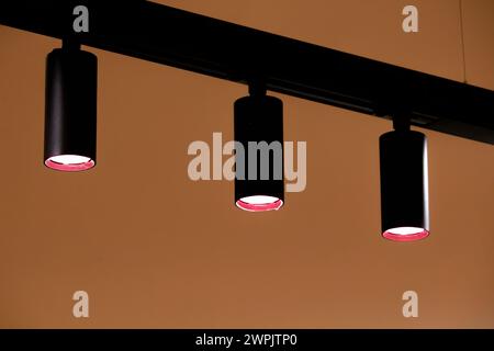 Three lamps and orange wall abstract background Stock Photo