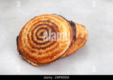 Jaffle, an old school toasted sandwich, filled with savory mince. Grey backdrop, copy space Stock Photo