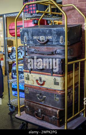 Old suitcases stacked up on trolley Stock Photo