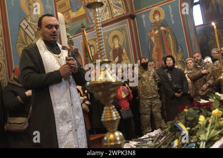 KYIV, UKRAINE - MARCH 7, 2024 - A priest conducts the memorial service ...