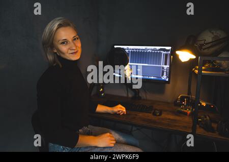 Young blonde woman reporter working on radio show, podcasting studio. High quality photo Stock Photo