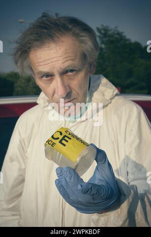 Crime scene investigation - collecting of evidences of soil samples on car wheel Stock Photo