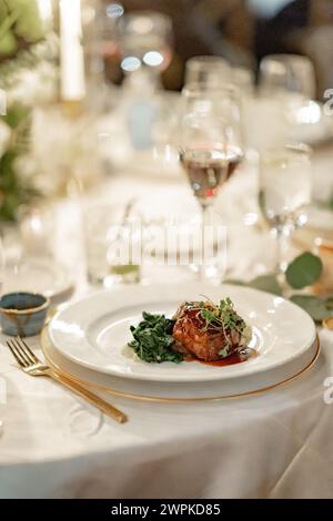 dinner table set with plated meal Stock Photo