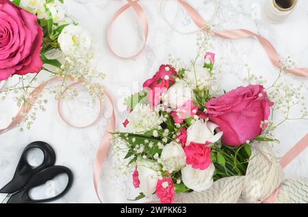 Anniversary celebration, congratulations, wedding, arrangement: white and pink flowers on a table. Stock Photo