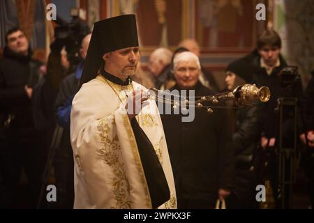 An Orthodox priest conducts a memorial service at the Garden of Memory ...
