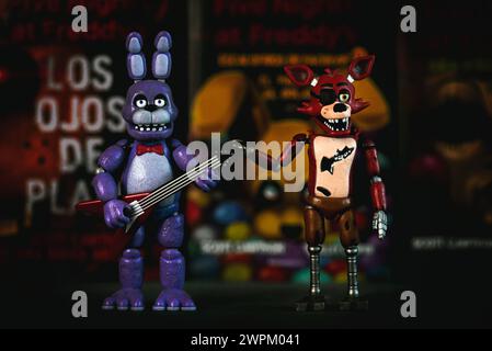 Figures of Bonnie and Foxy characters of the videogames,movies and books Five Nights at Freddy's in front of books. Illustrative editorial Stock Photo