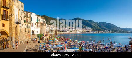 Panoramic view of tourists on beach, mountains in background, Cefalu, Province of Palermo, Sicily, Italy, Mediterranean, Europe Copyright: JohnxGuidi Stock Photo