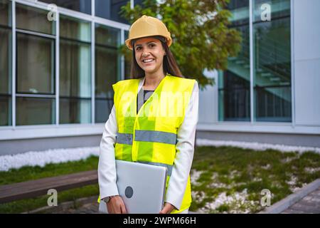 Smiling female safety engineer outdoors Stock Photo
