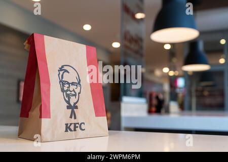 KFC paper bag with Kentucky Fried Chicken on the table of a KFC restaurant. Minsk, Belarus - March 8, 2024 Stock Photo
