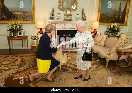 File photo dated 13/07/16 of Queen Elizabeth II welcoming Theresa May at the start of an audience in Buckingham Palace, London, where she invited the former home secretary to become prime minister and form a new government. Theresa May has said she will not fight the next general election, bringing a 27-year career in Parliament to an end. Issue date: Friday March 8, 2024. Stock Photo