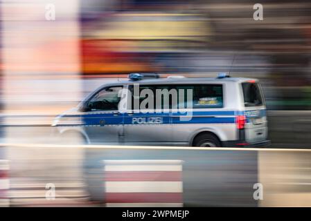 Dresden, Germany. 08th Mar, 2024. A police car drives along the Neustadt Leipziger Vorstadt near the Neustadt train station. (Shot with long exposure time) Credit: Robert Michael/dpa/Alamy Live News Stock Photo