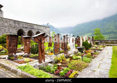 Graves at the terraced churchyard by the Parish Church of the Sacred Heart of Jesus, Lungern, Switzerland Stock Photo