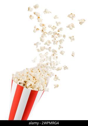 Popcorn flying from red and white striped container, isolated on white background. Stock Photo