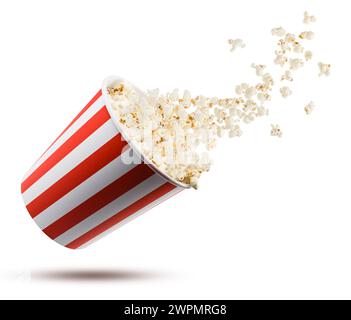 Popcorn flying from red and white striped container, isolated on white background. Stock Photo