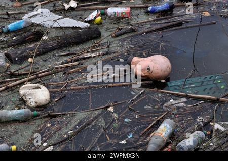 Detritus including plastic head etc floating on water at Salford Quays, Manchester Stock Photo