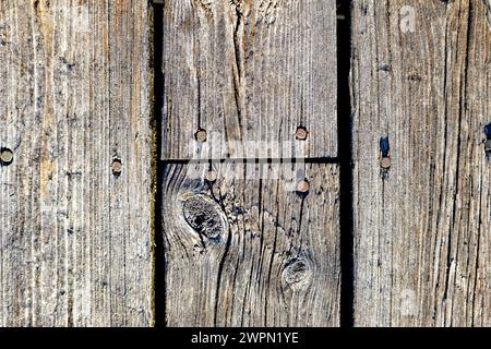 Old weathered wooden boards with rusty nails in close up image Stock Photo