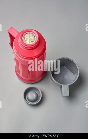 plastic thermos flask with cup, water bottle or container to keep beverages hot or cold for an extended period, mock-up template taken from above Stock Photo