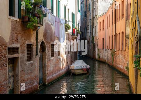 Canal in Venice between the old houses Stock Photo