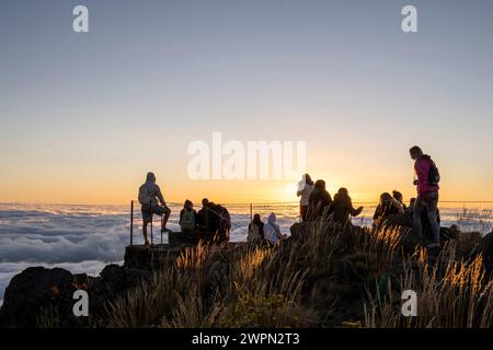Tourists at sunrise above the clouds, Miradouro do Pico do Areeiro, Madeira, Portugal, Europe Stock Photo