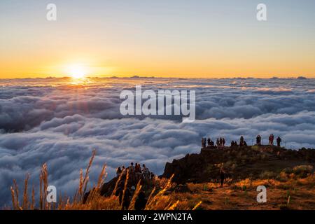 Tourists at sunrise above the clouds, Miradouro do Pico do Areeiro, Madeira, Portugal, Europe Stock Photo