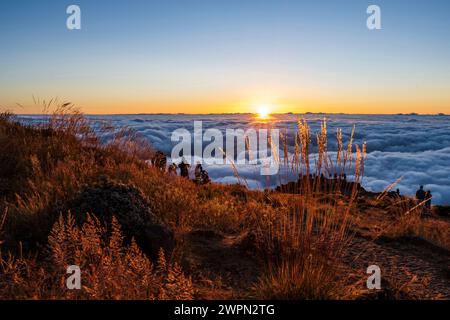 Tourists at sunrise above the clouds, Miradouro do Pico do Areeiro, Madeira, Portugal, Europe Stock Photo